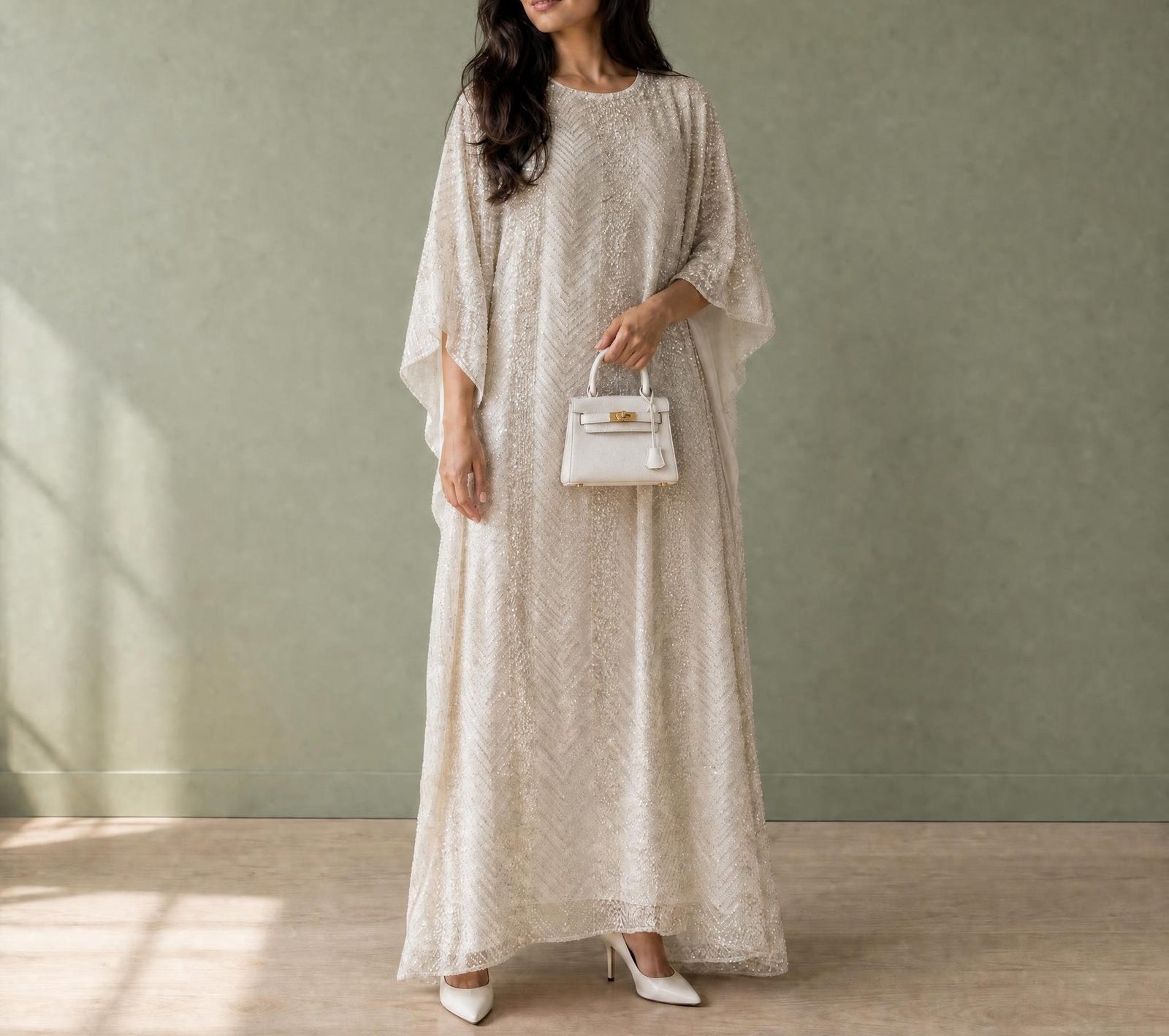 Model wearing Pearl's cream beaded kaftan in soft daylight